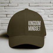Flexfit Kingdom Mindset hat in olive green with white embroidery on a textured background.