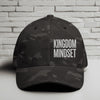 Flexfit Kingdom Mindset hat featuring clean white embroidery on a Multicam Black cap against a brick background.