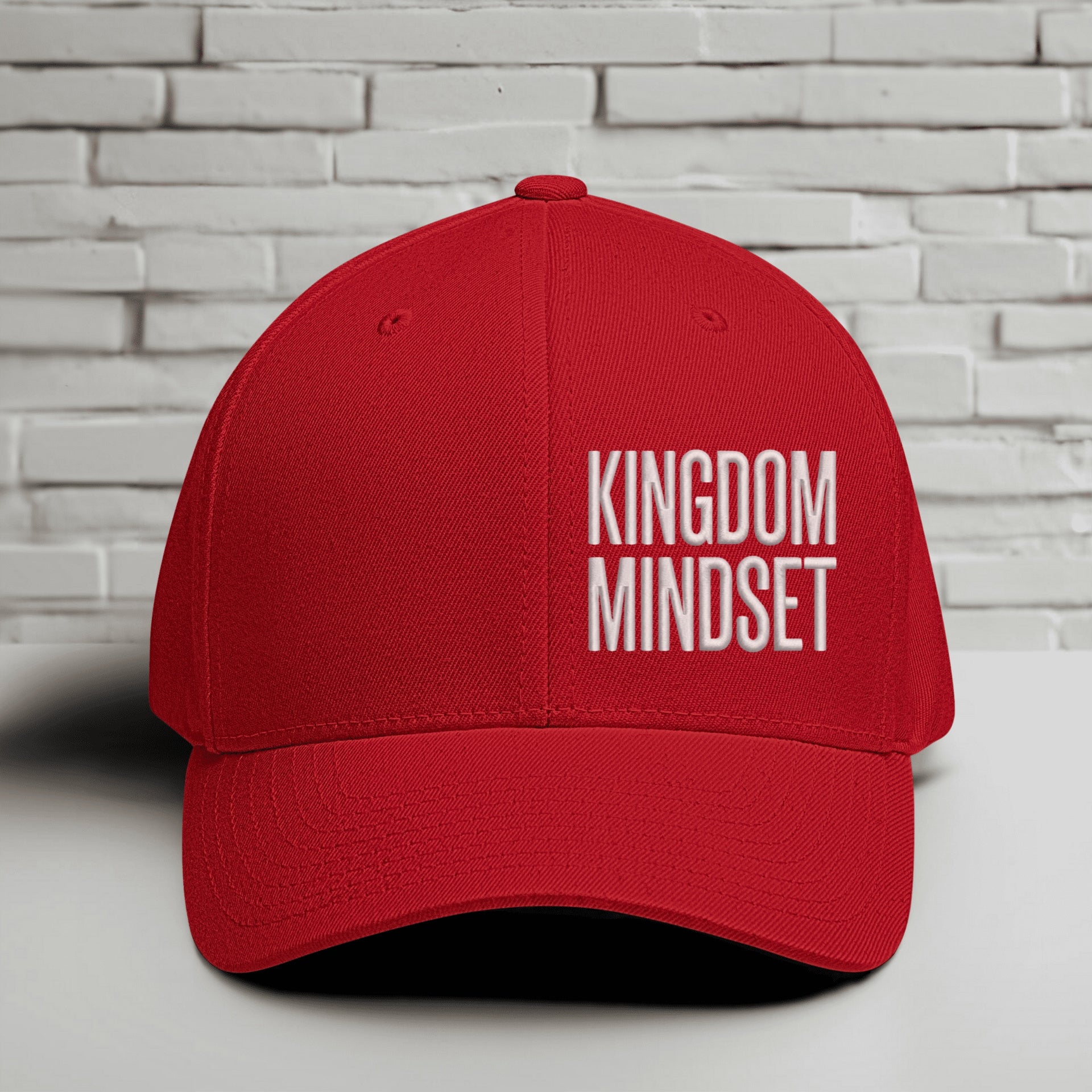 Flexfit Kingdom Mindset hat in red with white embroidery on a minimalist background.