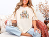 Christian autumn graphic t-shirt in ivory featuring Jesus, Flannels, Pumpkins, Sweaters, Blessings design, perfect for cozy fall vibes.
