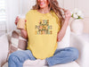 Christian autumn graphic t-shirt in mustard color featuring Jesus Flannels Pumpkins Sweaters Blessings text.