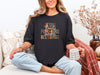 Christian autumn graphic t-shirt featuring Jesus, Flannels, Pumpkins, Sweaters, Blessings on a black tee.