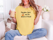 Woman in mustard Pumpkin Spice and the Spirit of Christ t-shirt, enjoying a drink, cozy autumn vibe.