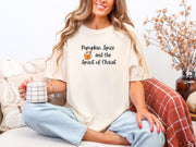 Pumpkin Spice Christian t-shirt in ivory worn by a woman holding a coffee mug, showcasing a cozy autumn vibe.