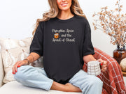 Woman wearing a black Pumpkin Spice Christian t-shirt, holding a coffee mug, celebrating autumn and faith.