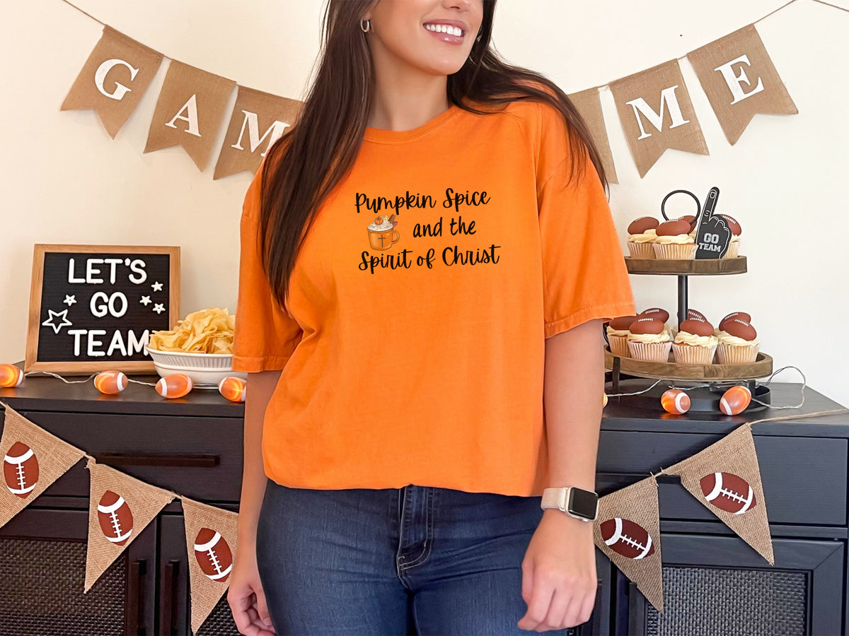 Burnt orange pumpkin spice Christian t-shirt worn by model at a festive autumn gathering with decor.