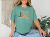 Fall for Jesus graphic tee in light green, showcasing the message 'Fall for Jesus, He Never Leaves' for autumn faith wear.
