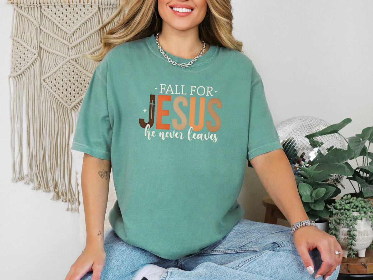Fall for Jesus graphic tee in light green, showcasing the message 'Fall for Jesus, He Never Leaves' for autumn faith wear.