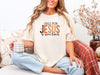 Model sitting with coffee, wearing Fall for Jesus graphic tee in ivory, celebrating faith and autumn.