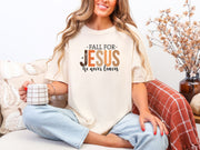 Model sitting with coffee, wearing Fall for Jesus graphic tee in ivory, celebrating faith and autumn.