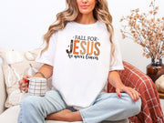 Fall for Jesus graphic tee worn by a woman holding a mug, showcasing a cozy autumn look on a white background.