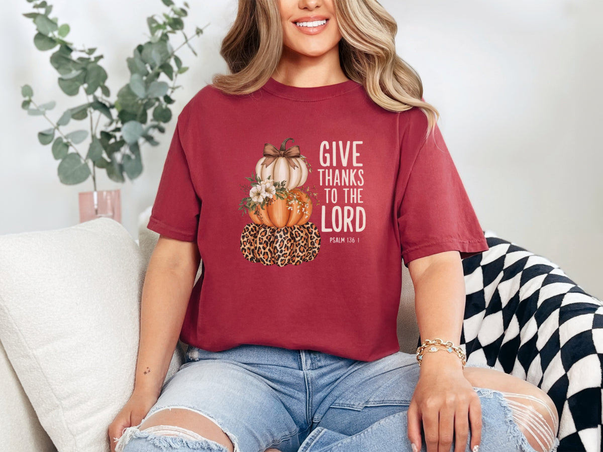 Give Thanks to the Lord t-shirt in chili color featuring pumpkin graphic design and inspiring quote by Psalm 136:1.