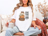 Woman wearing Give Thanks to the Lord t-shirt, featuring stacked pumpkins, celebrating gratitude and fall spirit.