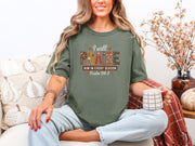 I Will Praise Him in Every Season Christian graphic tee praise in moss color, worn by a woman holding a mug.