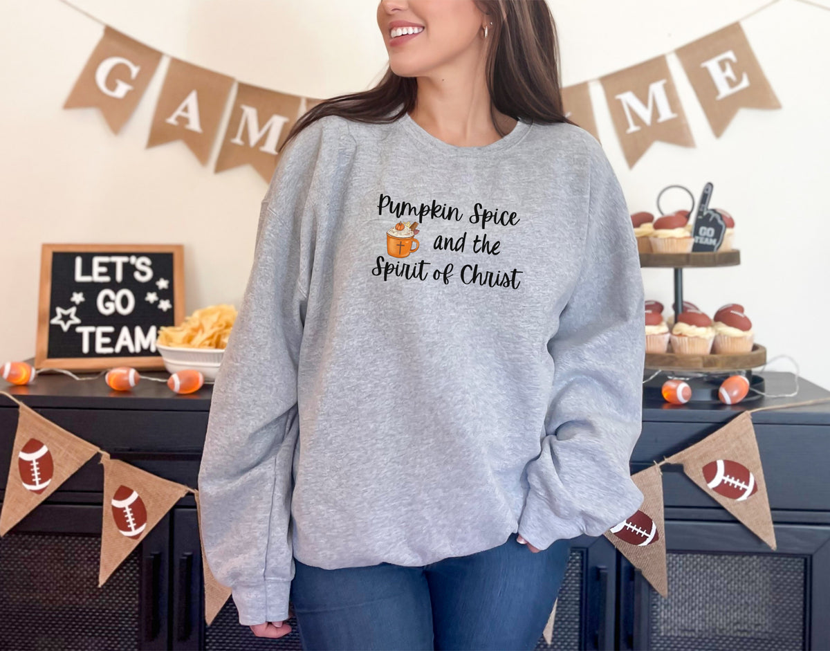 Woman wearing a pumpkin spice Christian sweatshirt in sport grey, perfect for autumn and celebrating faith.