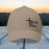 Man of God Dad Husband Embroidered Flexfit Hat in khaki displayed against a sunset background.